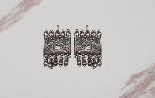 Close-up of traditional silver jhumki earring design detail