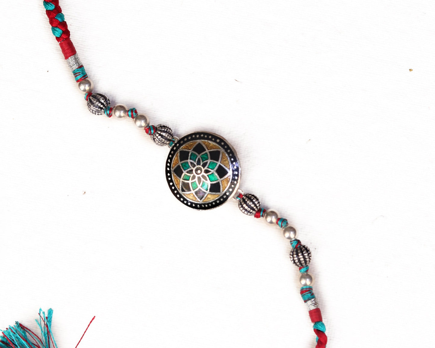 silver rakhi bracelet design mandala mosaic worn on wrist